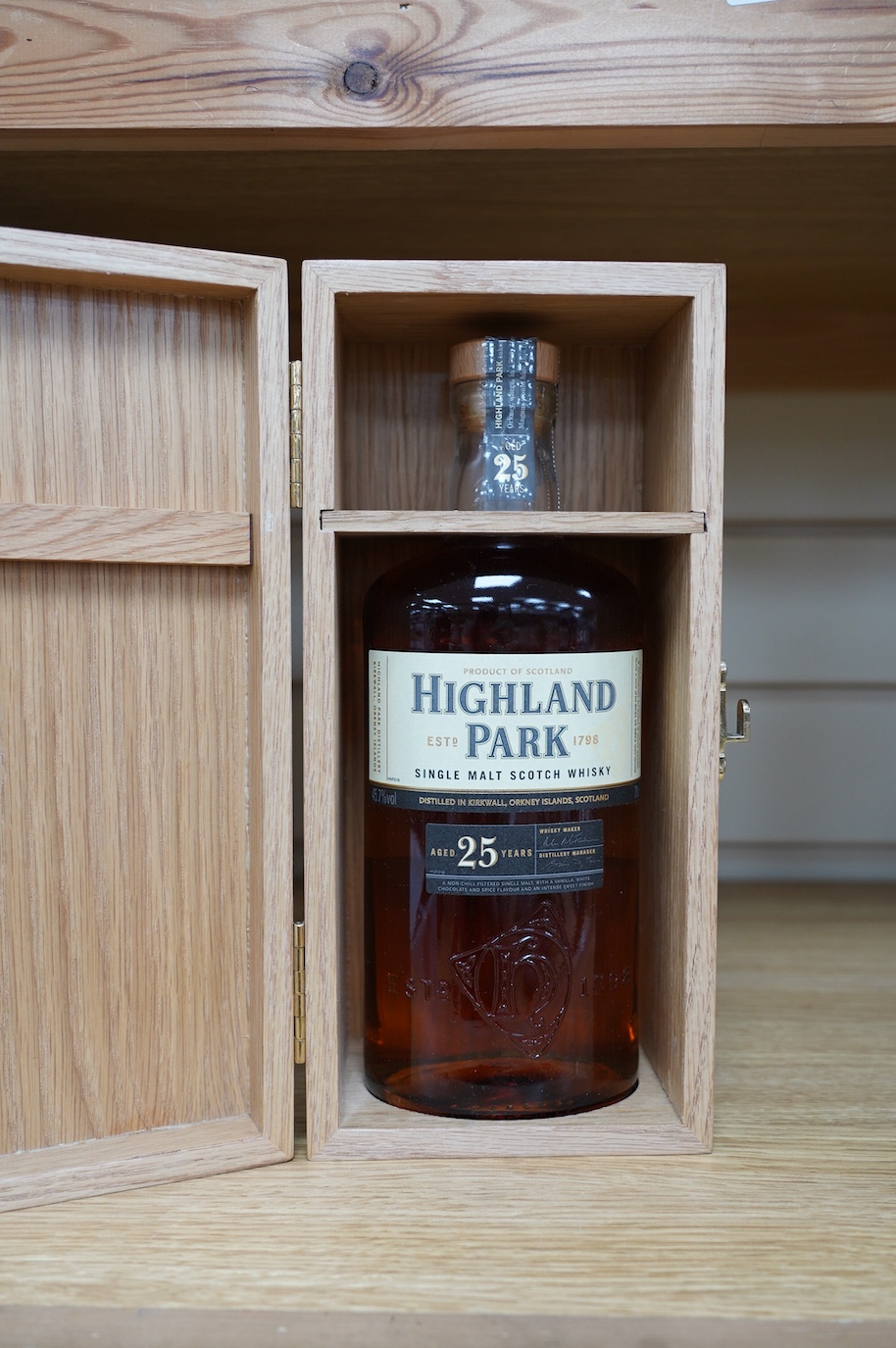 A wood cased bottle of Highland Park 25 year old whisky. Condition - good